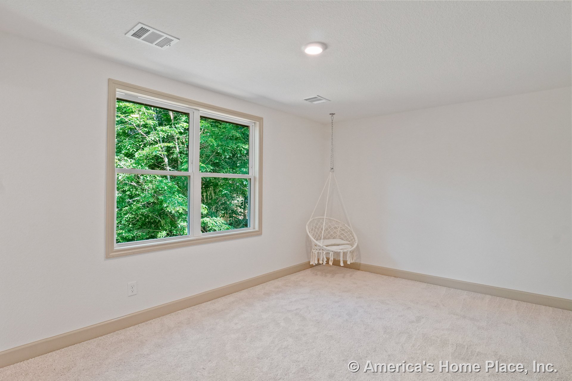 Bedroom with large double window framed in beige trim, beige carpet flooring, neutral painted walls, beige baseboards, recessed ceiling light, and ceiling vent covers.