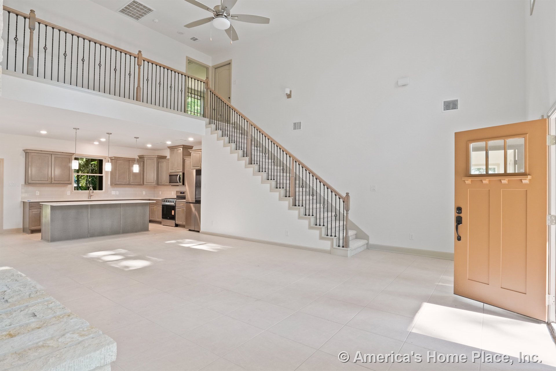 Open-concept living area with tile flooring, shaker kitchen cabinets, stainless steel appliances, large kitchen island under pendant lights, recessed lighting, wood and iron