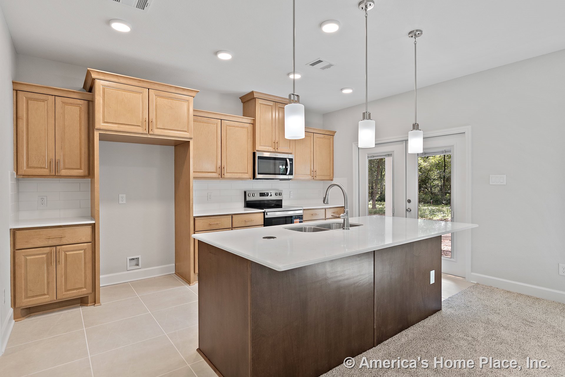 Light wood cabinetry kitchen with white quartz island, stainless steel appliances, built-in microwave, electric range, subway tile backsplash, tile flooring, pendant and recessed