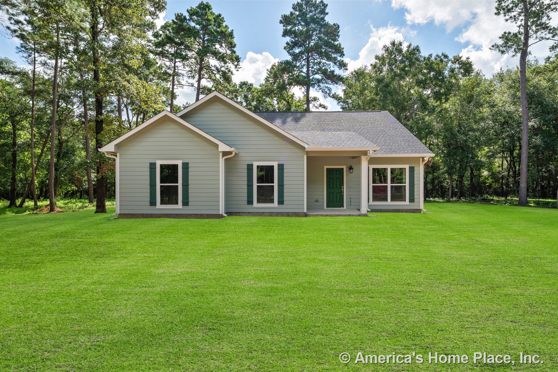 Horizontal lap siding exterior with green shutters, double-hung windows, gable roof, and covered front porch featuring a green entry door.