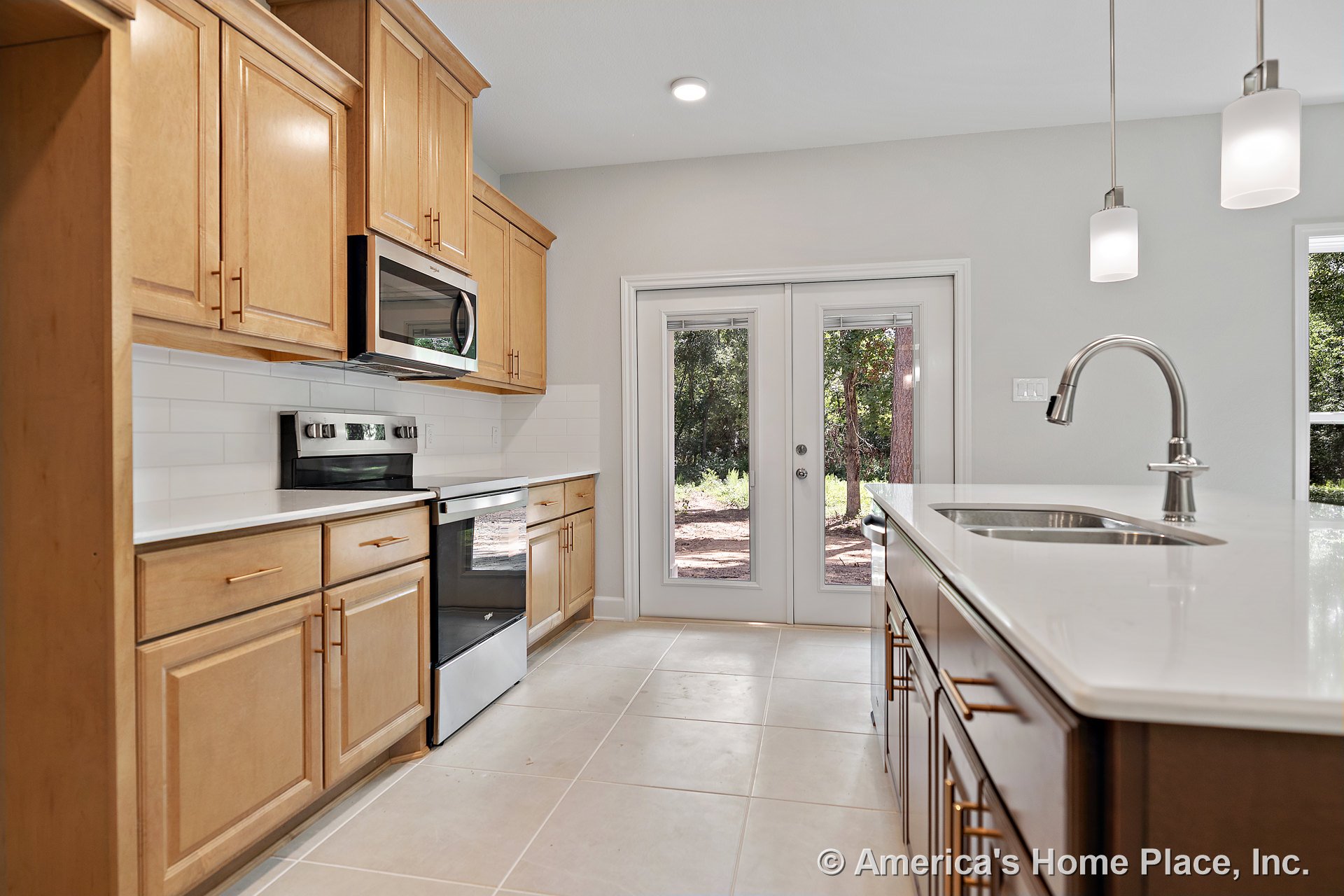 Light wood cabinetry and quartz countertops with tile flooring, central kitchen island, pendant and recessed lighting, built-in microwave, electric range, subway tile backsplash