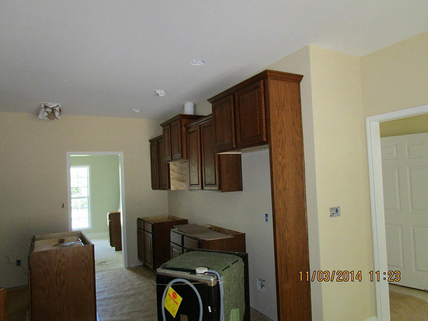 Modern kitchen with white shaker cabinets, stainless steel appliances, quartz countertops, and recessed lighting