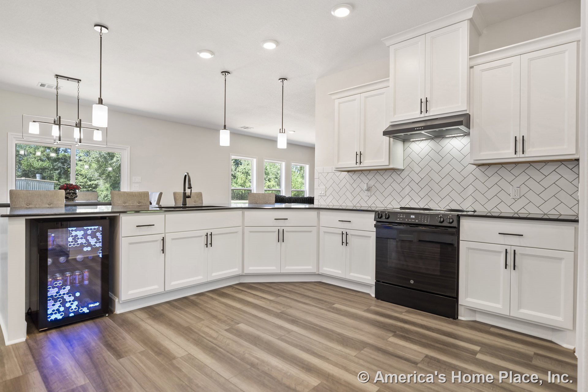 White shaker cabinets and black countertops with herringbone tile backsplash, pendant lighting, built-in beverage cooler, black electric range, large windows, wood-look flooring