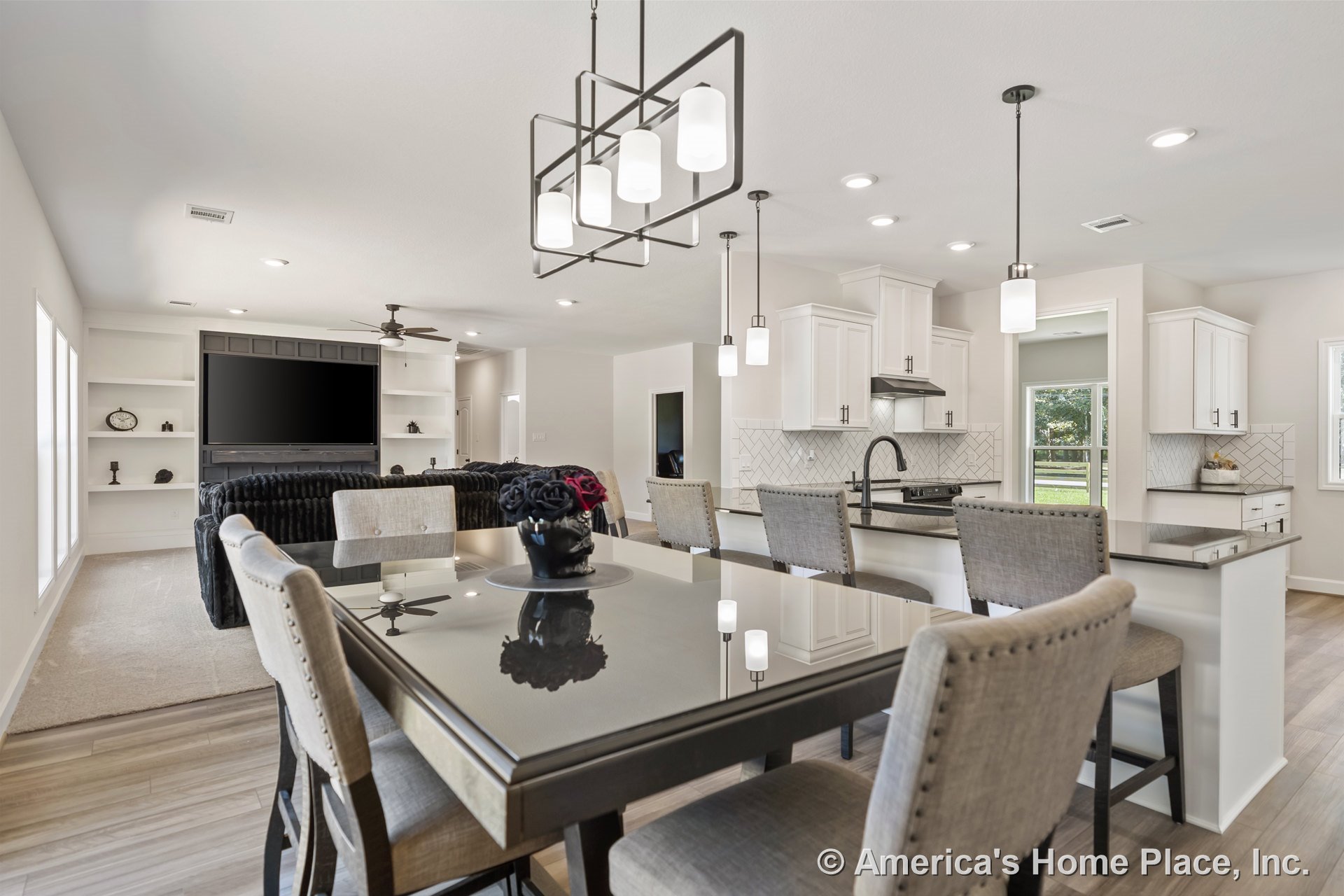 Open-concept kitchen and living area with white shaker cabinets, herringbone tile backsplash, large island featuring dark countertops and island seating, pendant and recessed