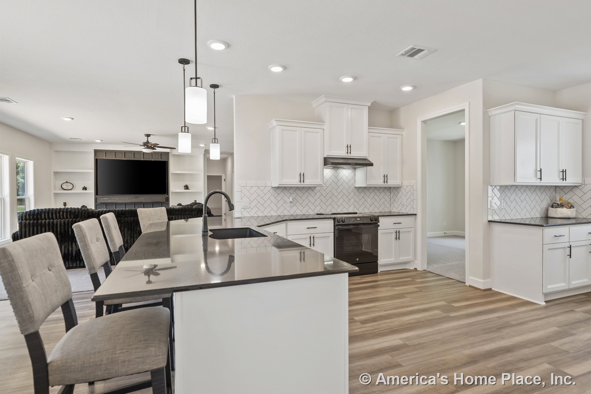 Open concept kitchen with white shaker cabinets, herringbone tile backsplash, quartz island countertop, pendant and recessed lighting, wood-look flooring, and stainless range hood.