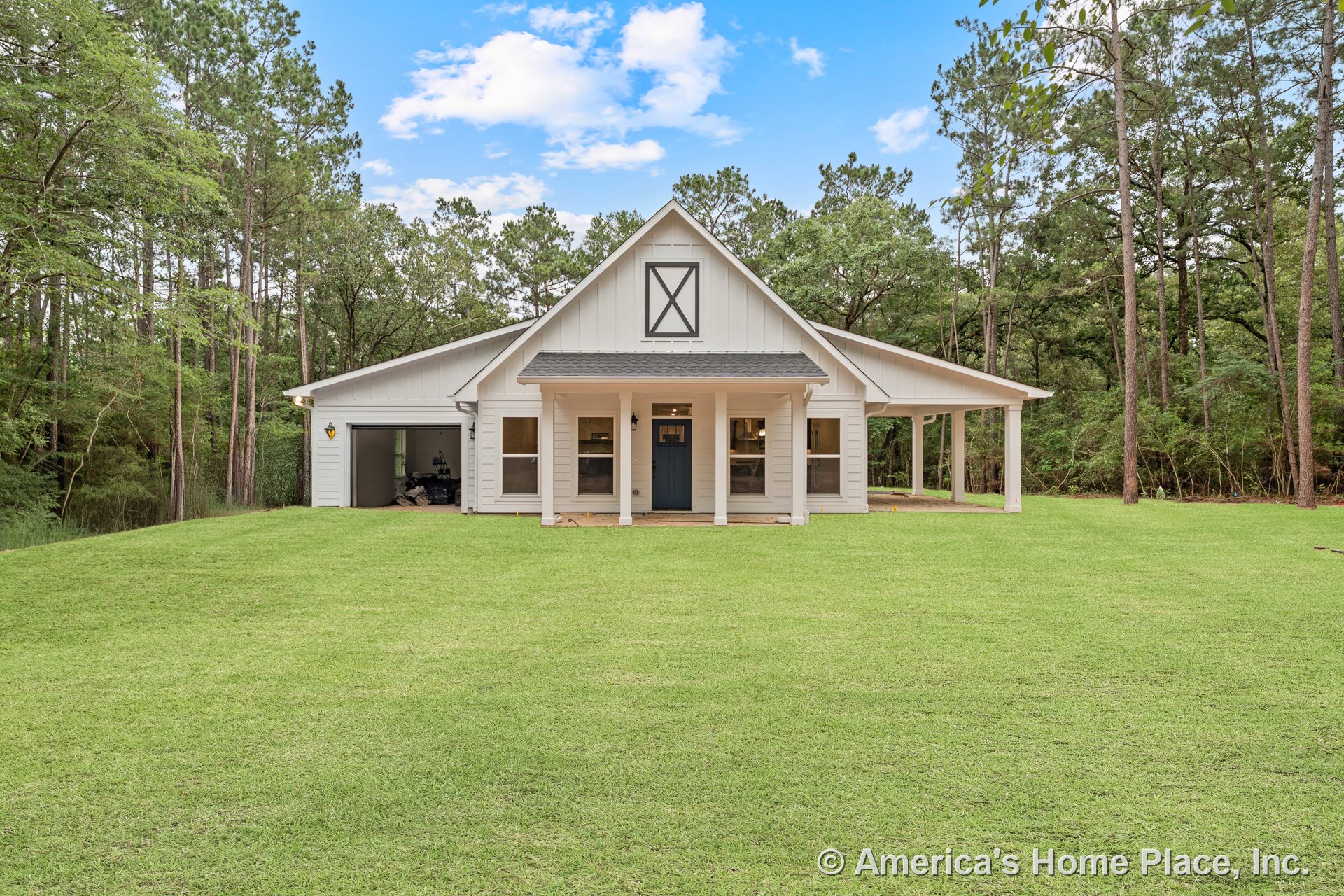 Covered front porch with board and batten siding, gable roof featuring decorative trim, attached carport, double front windows, white exterior finish, permanent lighting, rural