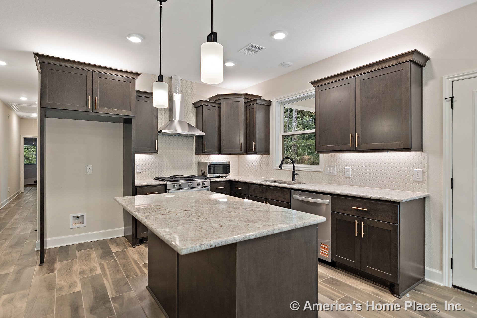 Dark wood cabinetry and granite island countertop with hexagonal tile backsplash, stainless steel range hood, pendant and recessed lighting, wood-look tile flooring, window above
