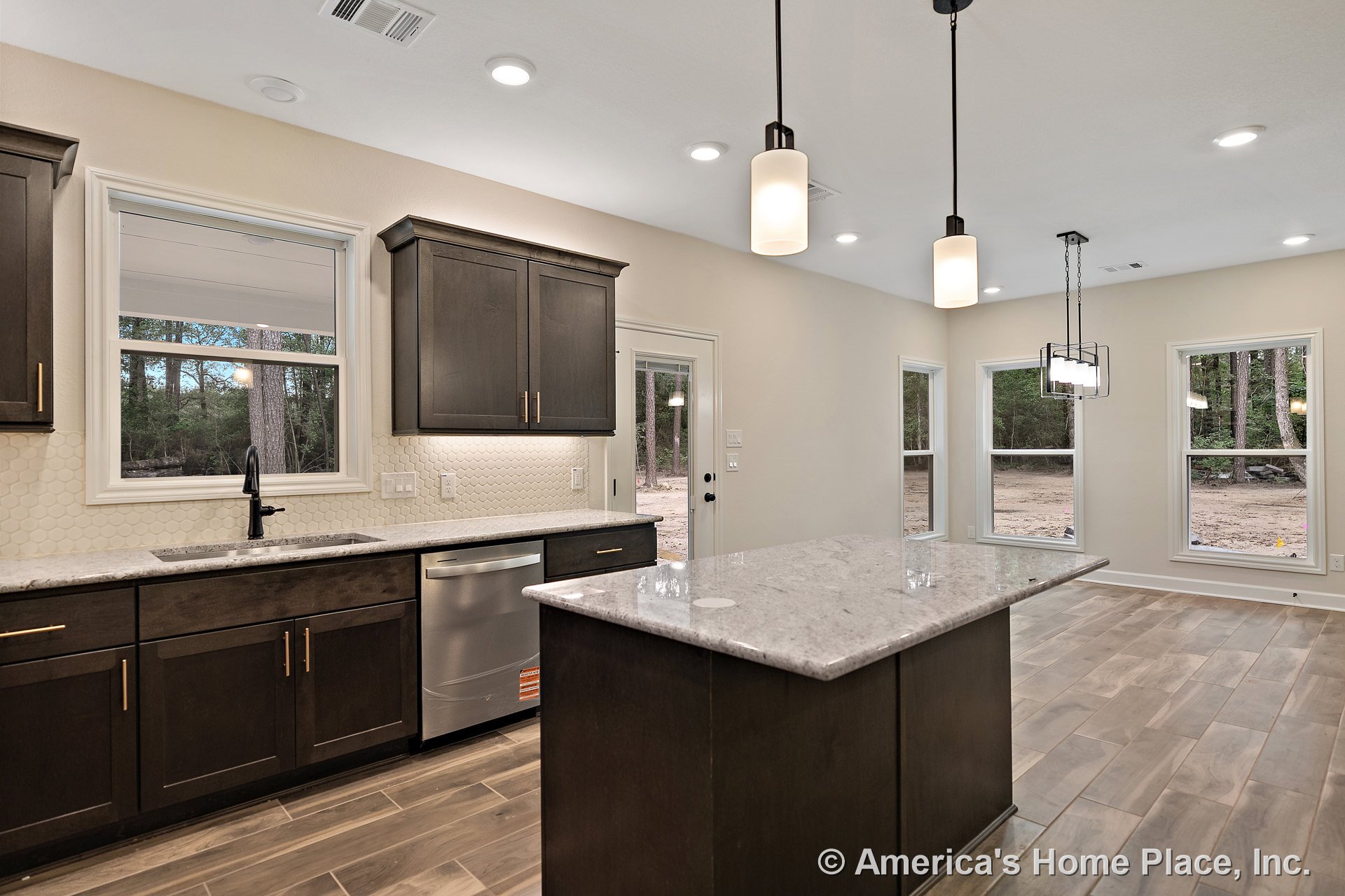Dark wood cabinetry and a large stone countertop island with stainless steel sink, hexagonal tile backsplash, recessed ceiling lights, pendant lighting fixtures, wood-look tile
