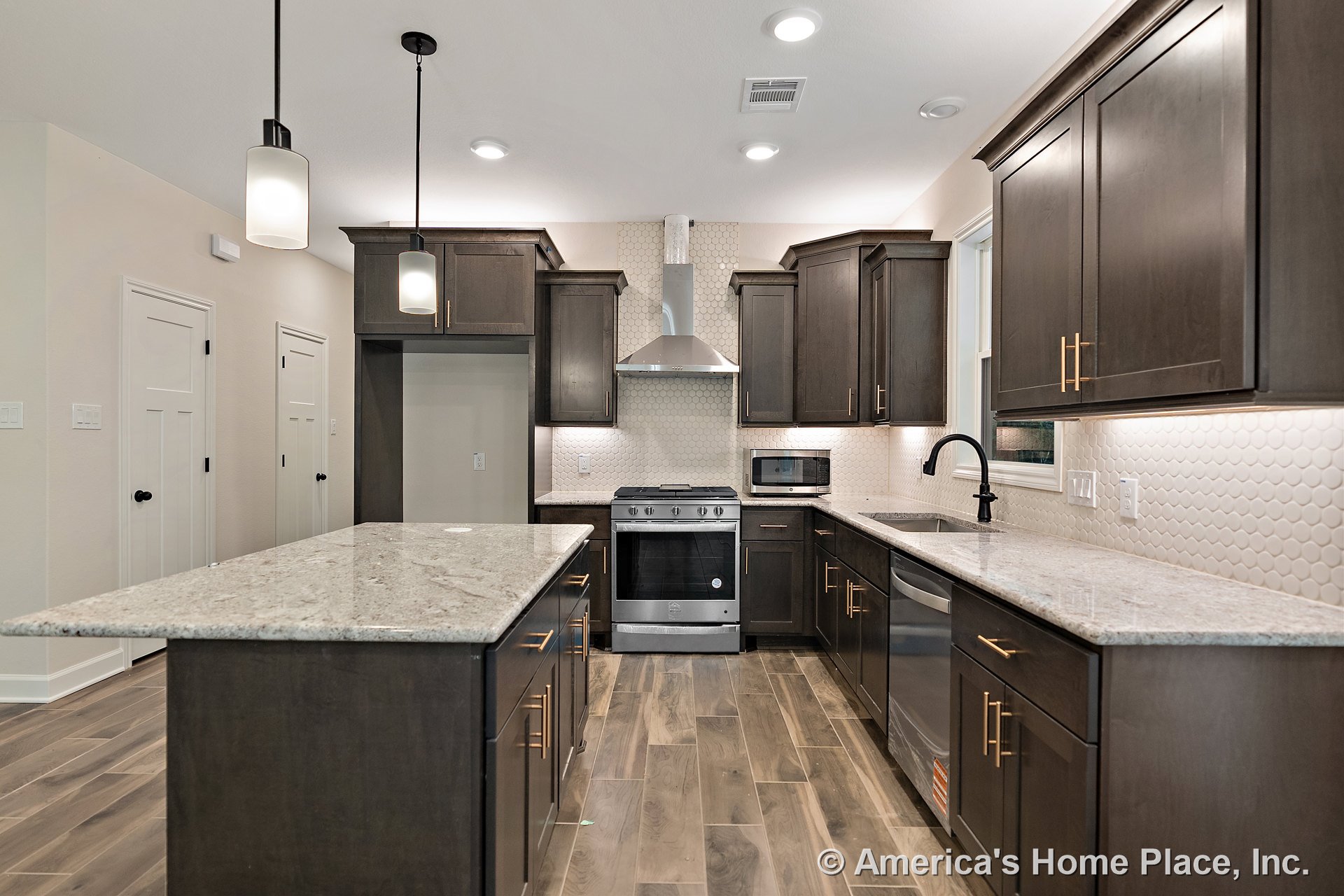 Dark wood cabinetry with granite countertops, hexagonal tile backsplash, stainless steel range and hood, pendant lighting fixtures, under-cabinet lighting, double-door pantry