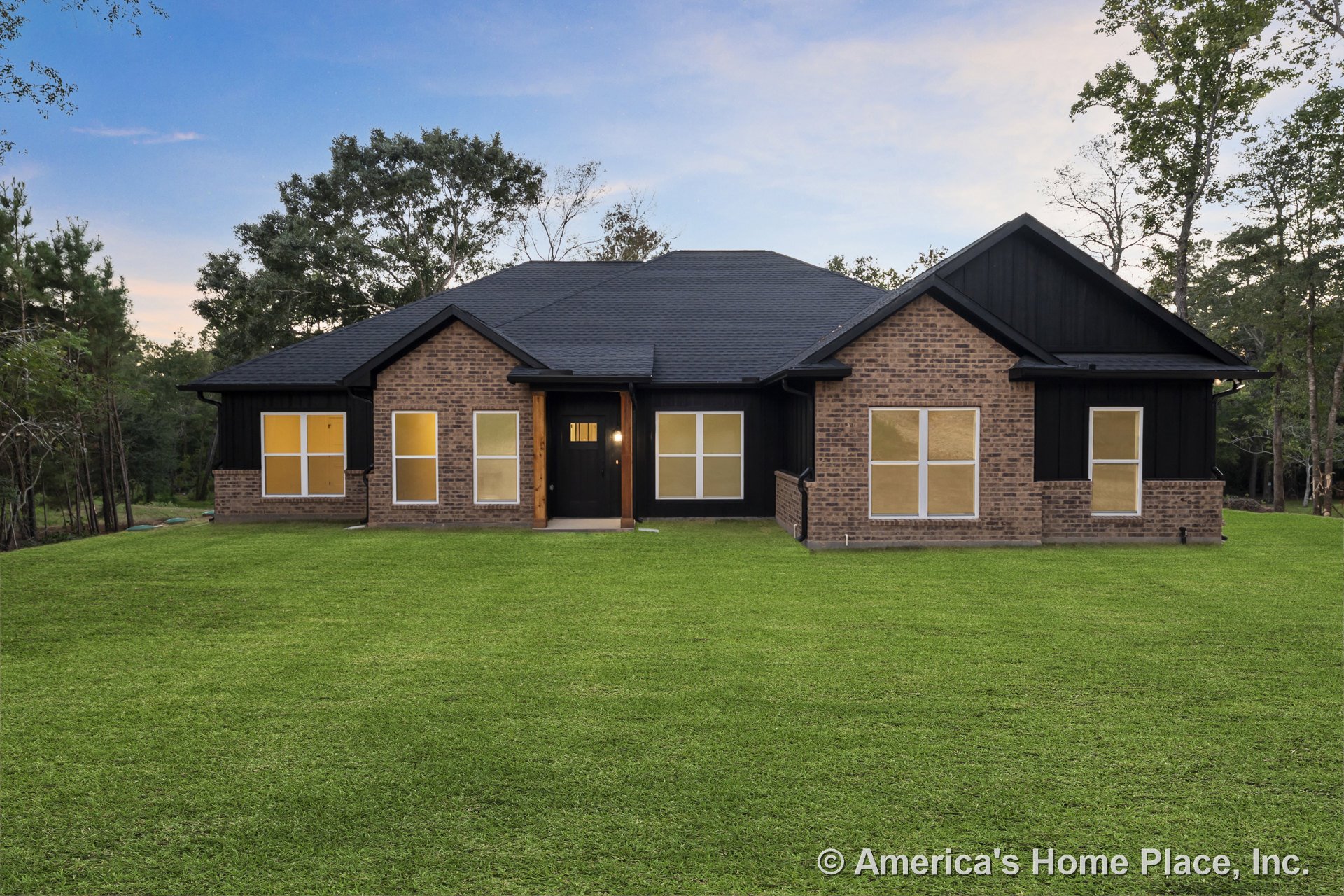 Brick exterior with black trim, large rectangular windows, covered front entry supported by wooden columns, black roof shingles, single-story modern design.
