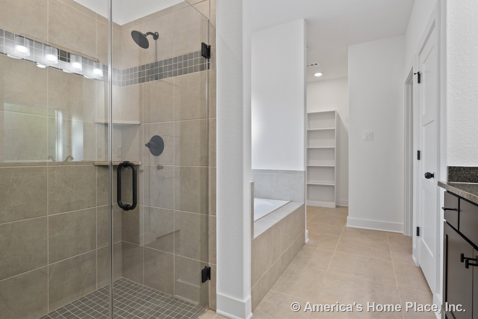 Glass-enclosed shower with tiled walls and shower niche, built-in bathtub, open shelving, matte black hardware, tile flooring, recessed lighting, white trim, and interior door.