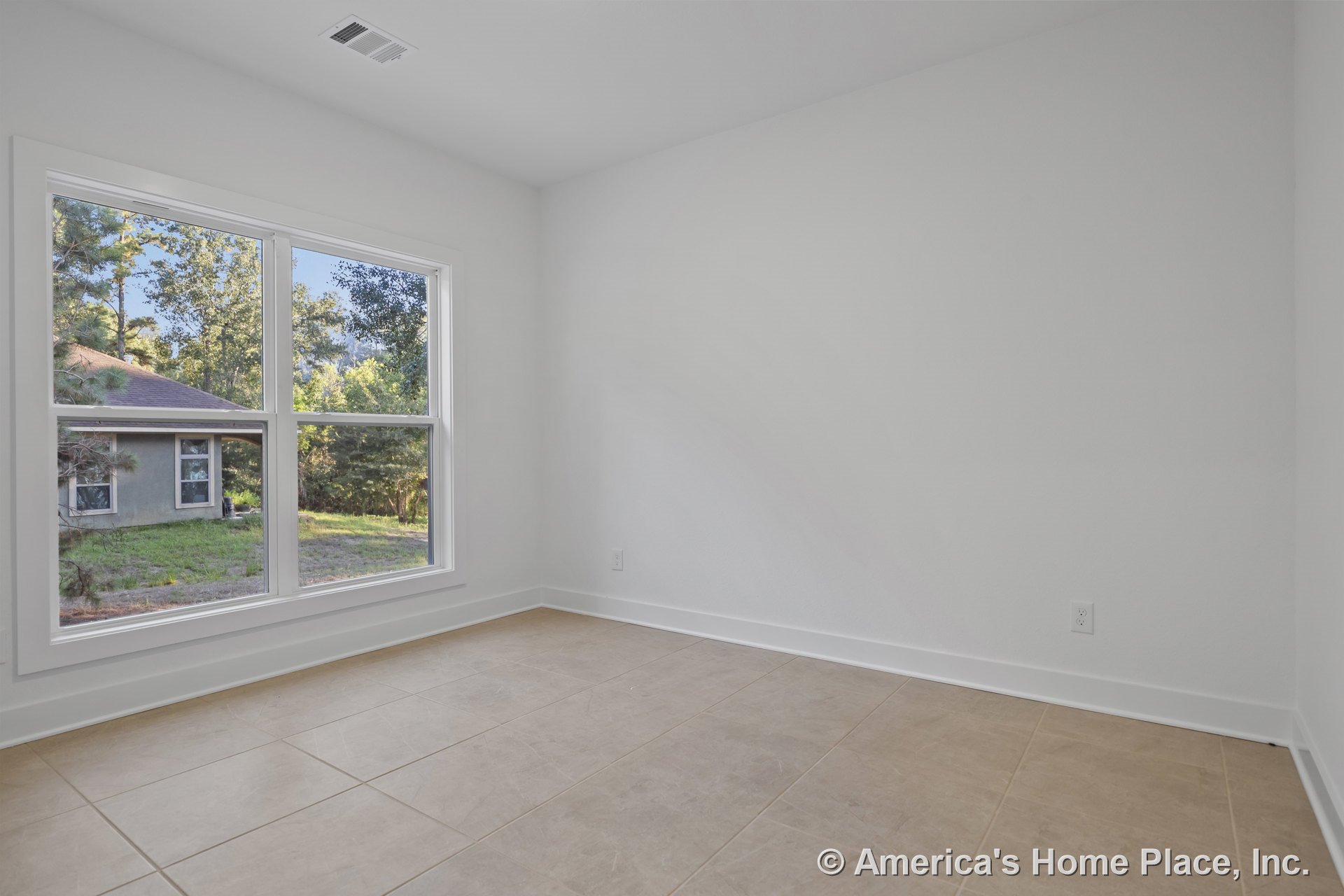 Large double-pane windows with white trim, beige ceramic tile flooring in a rectangular pattern, smooth white walls, white baseboards, ceiling vent, and abundant natural light in