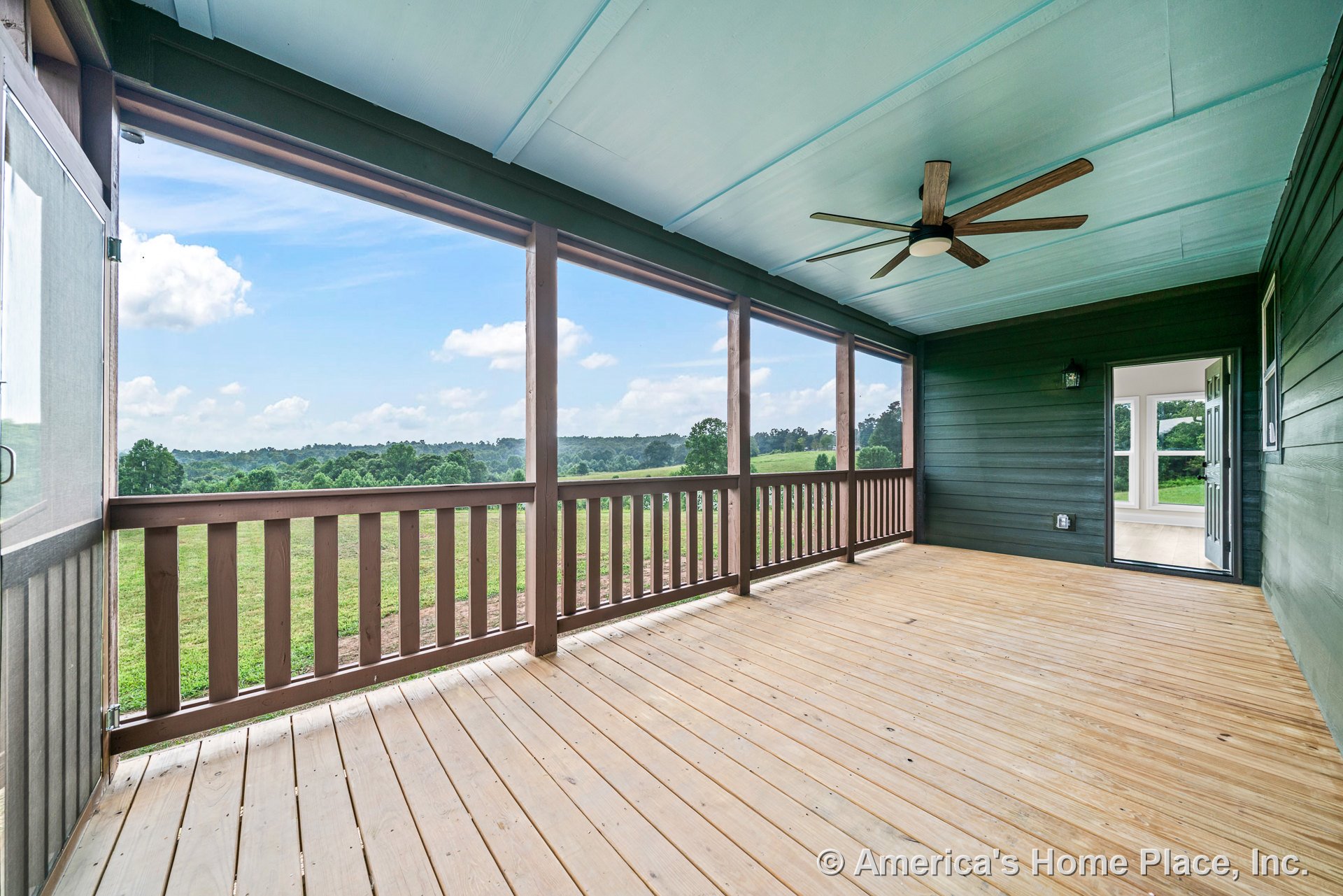 Screened porch with wood plank flooring, painted ceiling, ceiling fan, wood railing, exterior wall siding, trim, door, and windows.