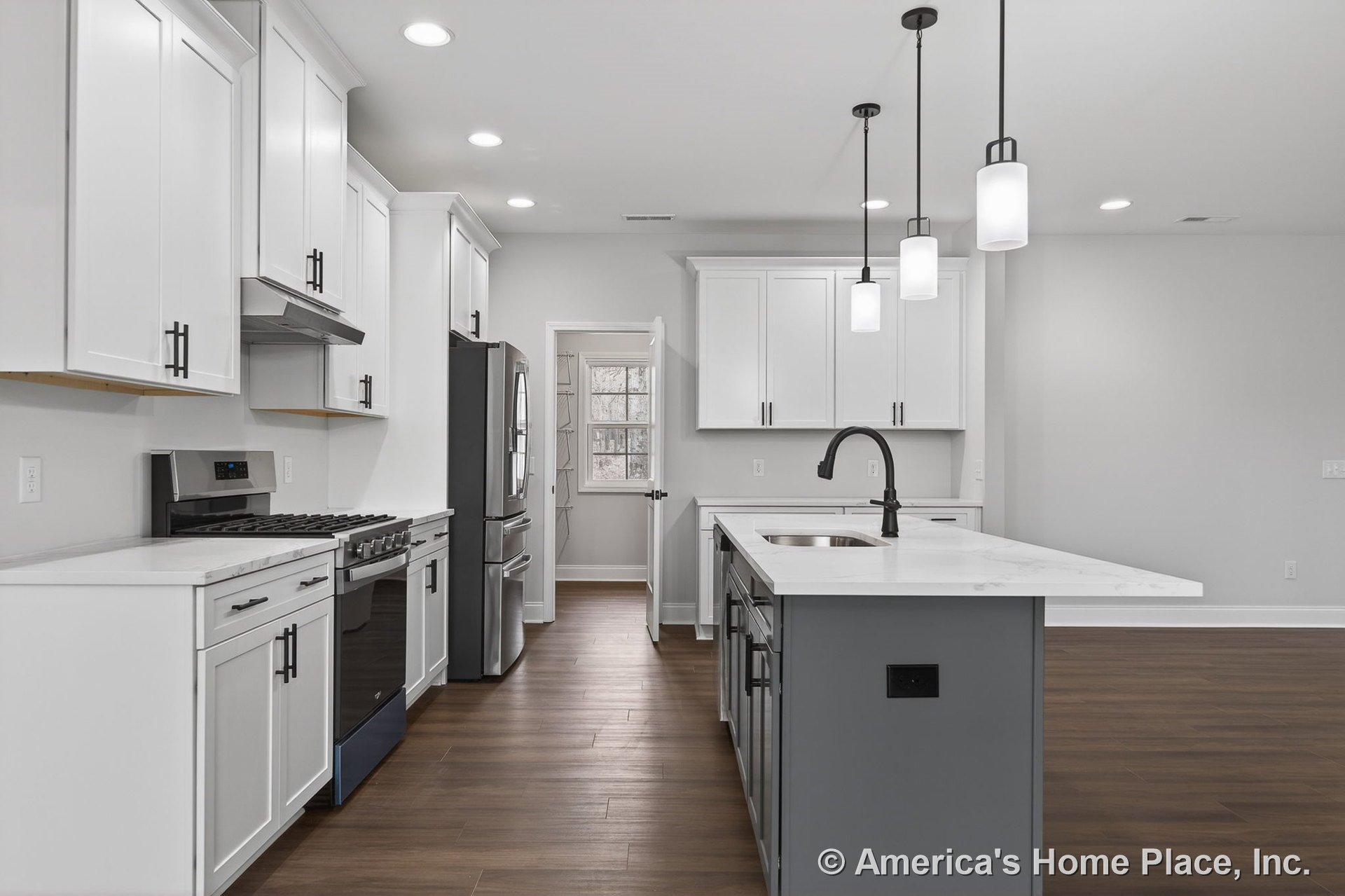 White shaker cabinets and quartz countertops in a kitchen with stainless steel range and refrigerator, pendant lights above the island, undermount sink with black faucet, wood-look