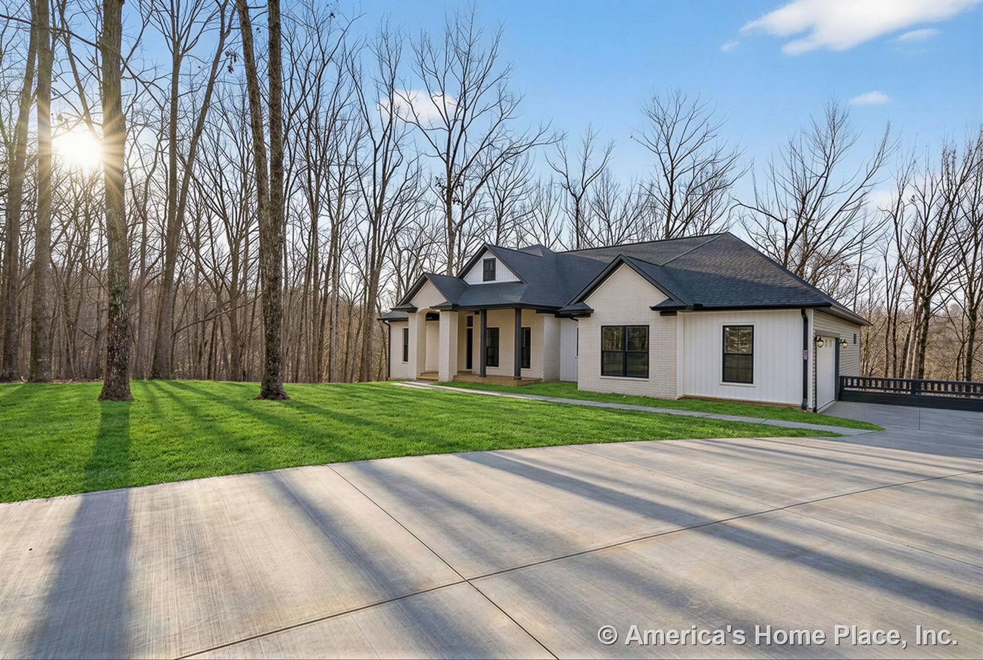 Light brick siding with black window trim, covered front porch, concrete driveway, gabled roof, large windows, attached garage, and landscaped front yard.