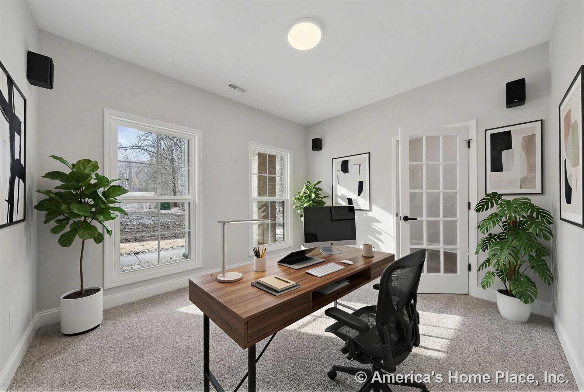 Carpeted home office with rectangular windows featuring modern white trim, glass-paneled door with metal hardware, recessed ceiling light, and neutral walls allowing natural light.