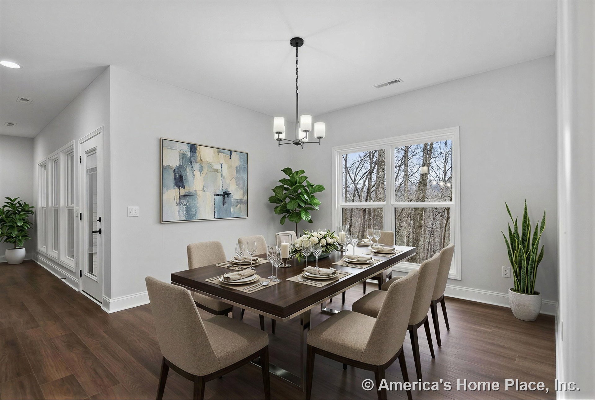 Dining room with double-pane windows, wood plank flooring, white trim, modern ceiling light fixture, neutral wall paint, and interior glass door.