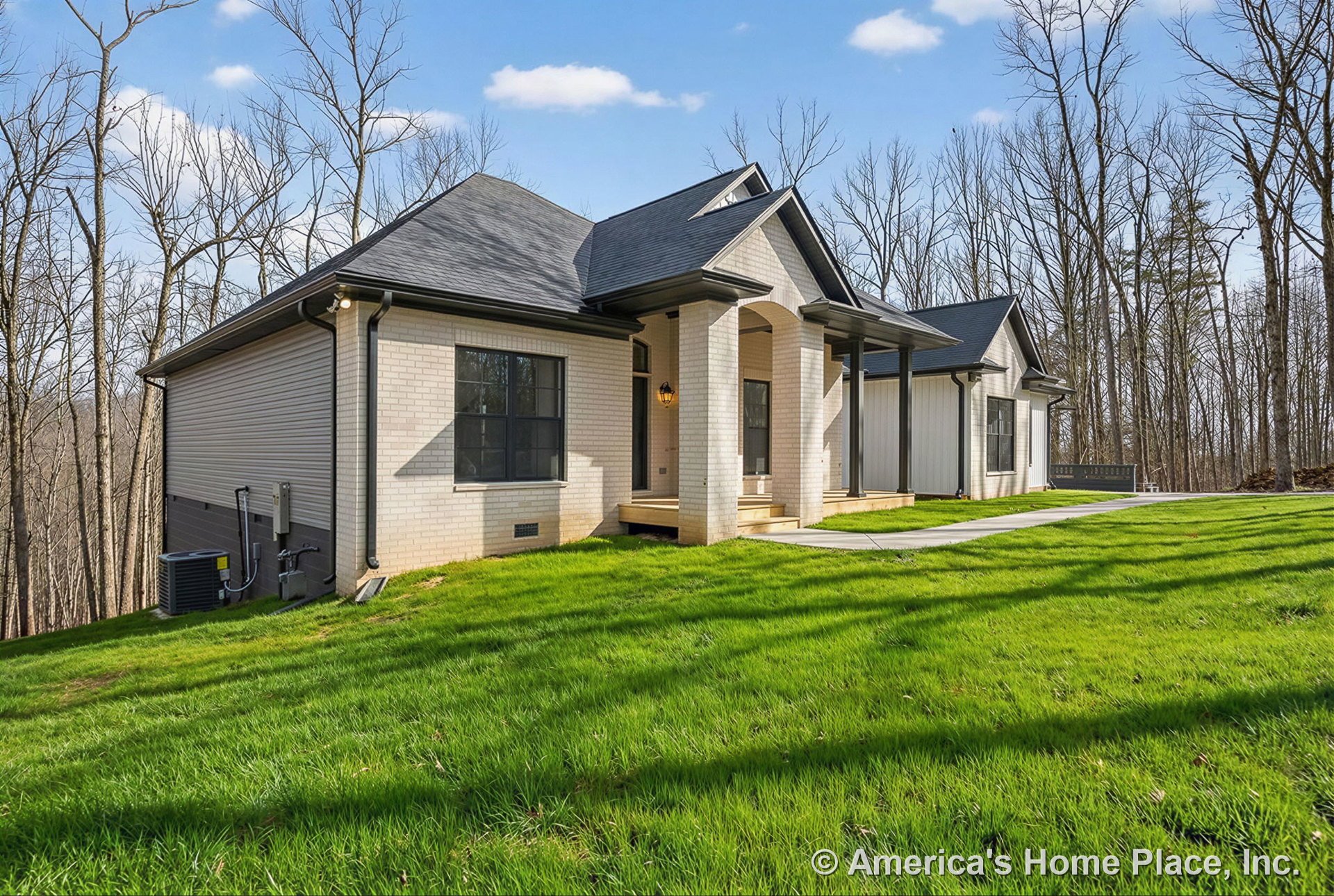 Brick exterior with covered front porch, black window frames and trim, concrete walkway, black roof shingles, exterior lighting fixture, entry steps, and porch columns.