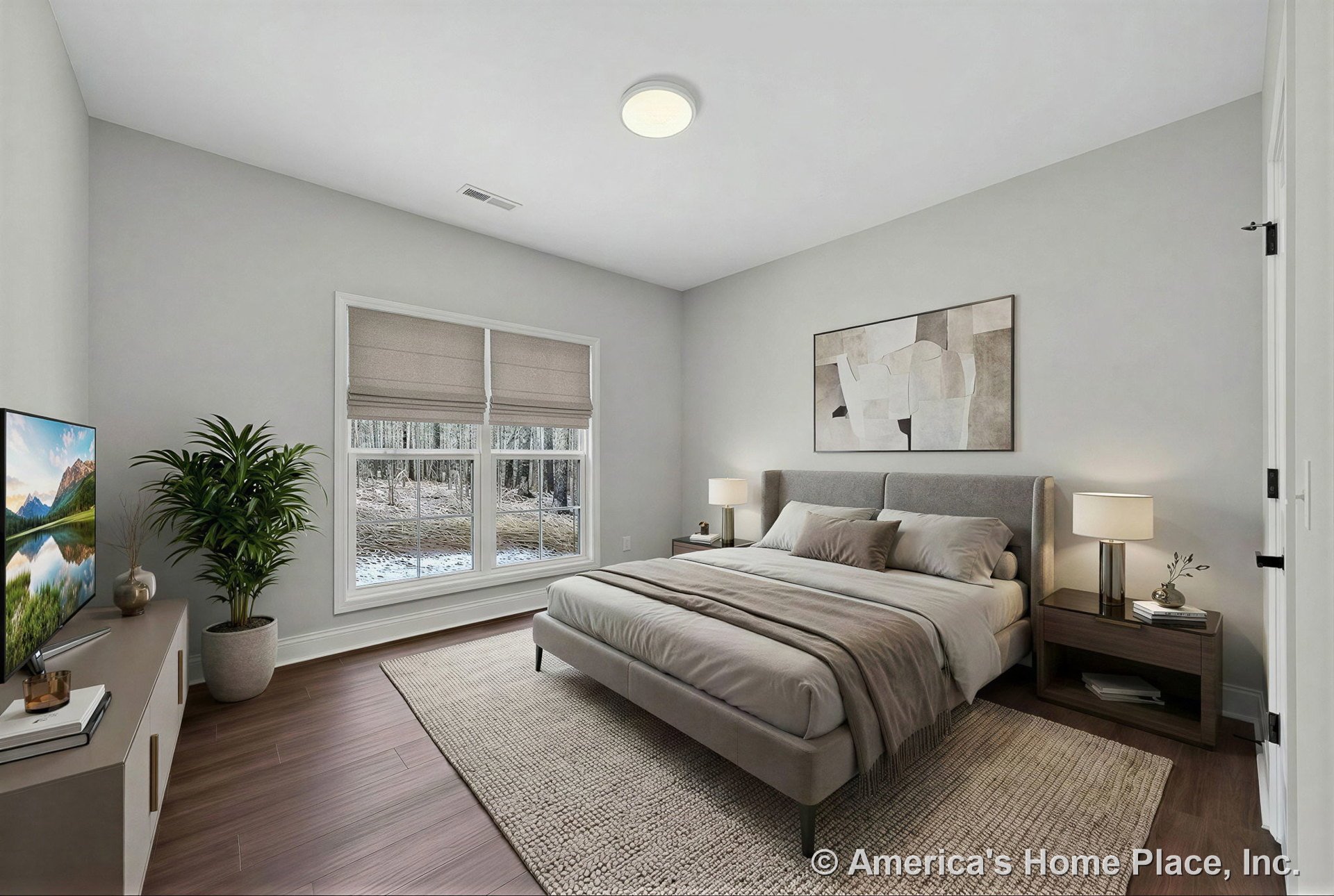 Wide plank wood flooring, double window with white trim and Roman shades, flush mount ceiling light, white painted walls, modern interior door, baseboard trim, and neutral finishes