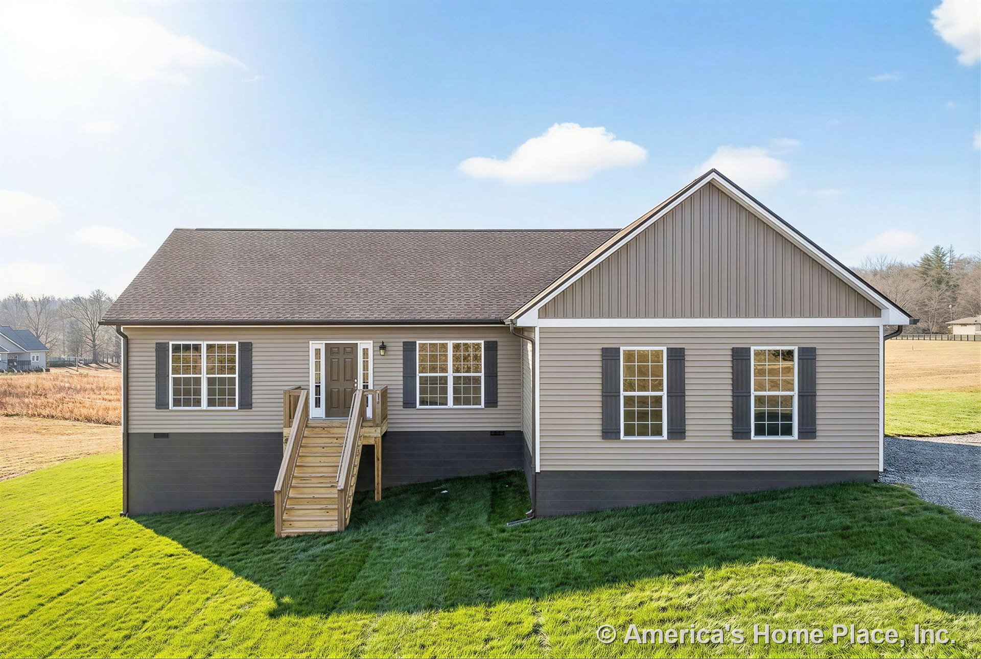 Wooden front steps lead to a porch entry with double-hung windows framed by shutters, vinyl siding exterior, gable roof, front door with side panels, decorative trim accents, and