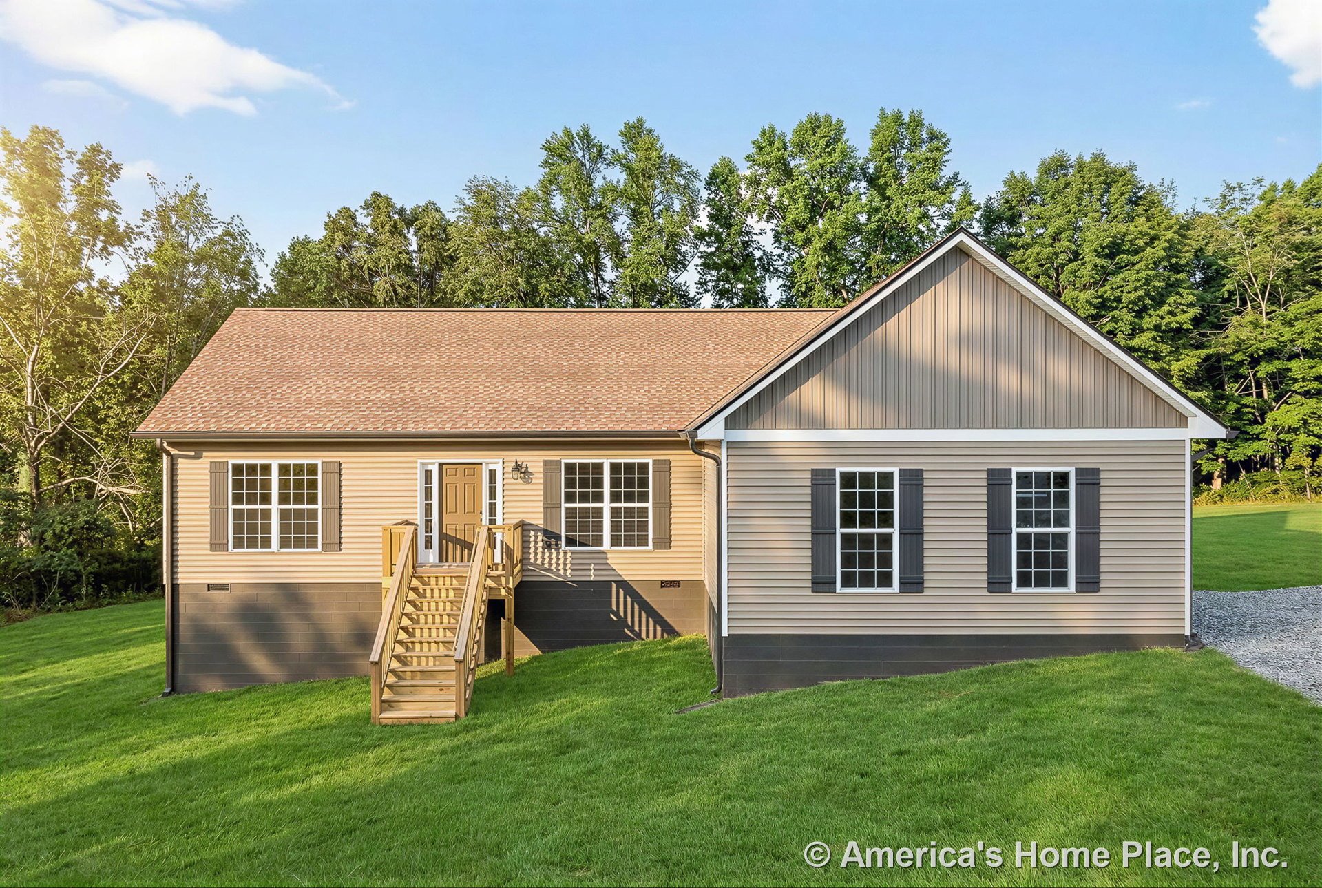 Tan vinyl siding exterior with gable roof and asphalt shingles, wooden front porch and entry stairs, double-hung windows with shutters, decorative trim around windows and doors