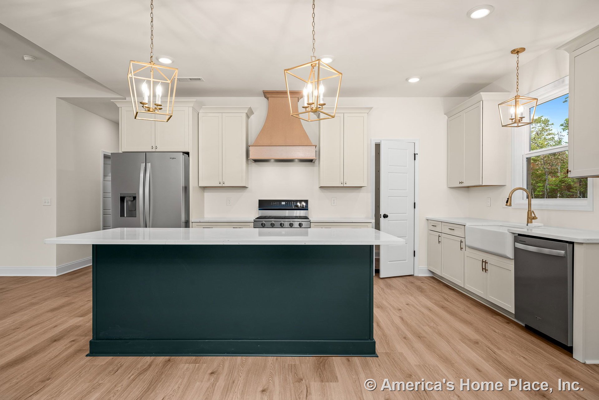 Large kitchen with central island featuring white quartz countertops, shaker-style cabinetry, stainless steel appliances, farmhouse sink, wood-look flooring, gold-finished pendant