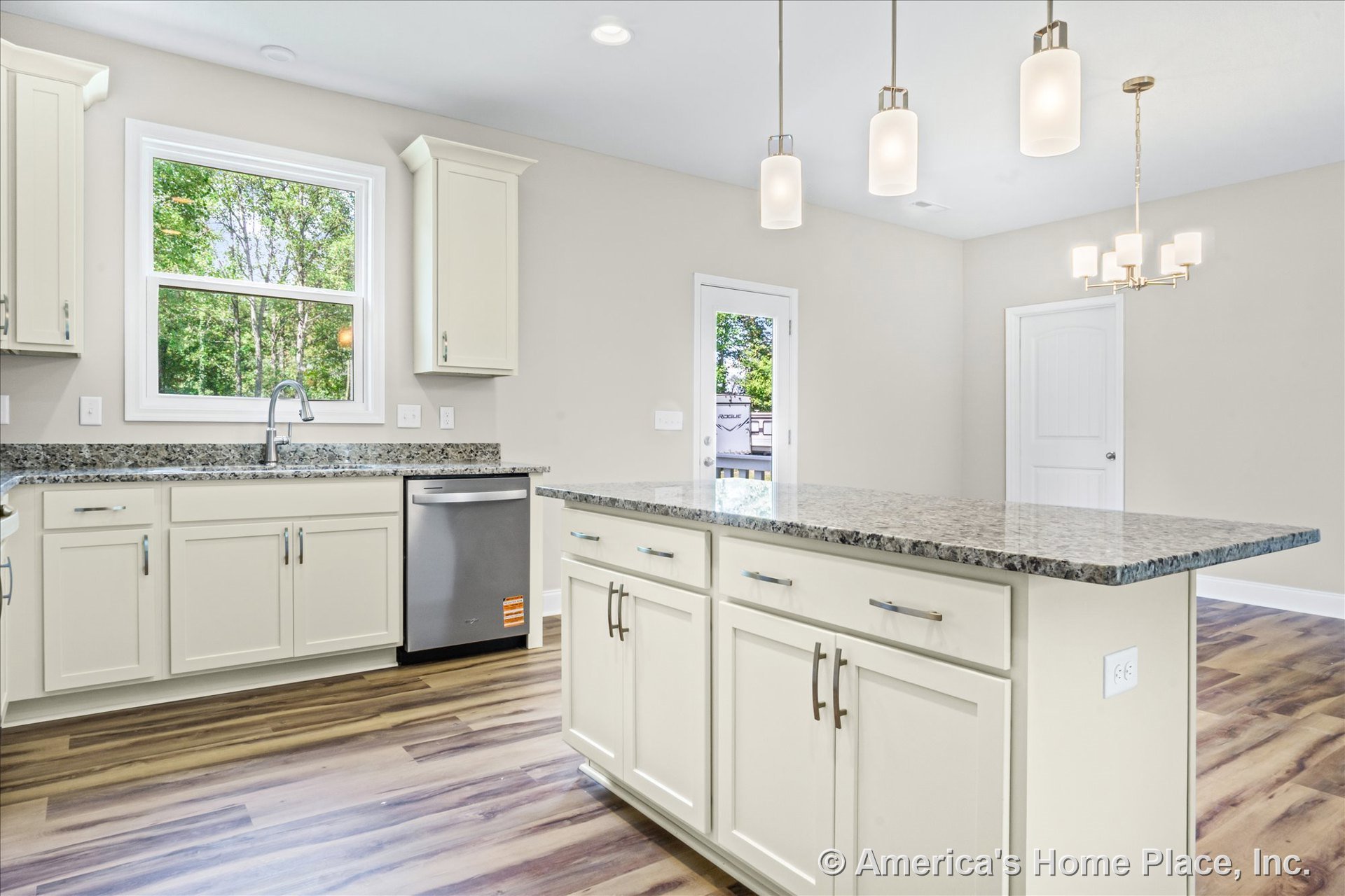 Cream shaker cabinets and granite countertops with a central kitchen island, stainless steel dishwasher, wood-look flooring, large window above the sink, modern pendant lights