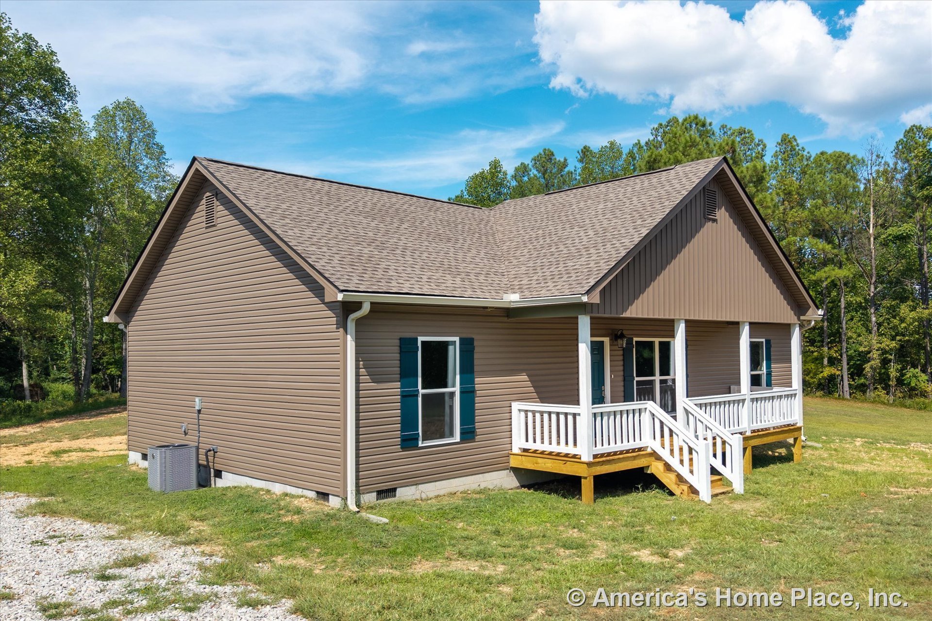Brown vinyl siding exterior with gable roof, covered front porch featuring white railings and steps, double-hung windows with white trim, central HVAC unit beside entry, one-story