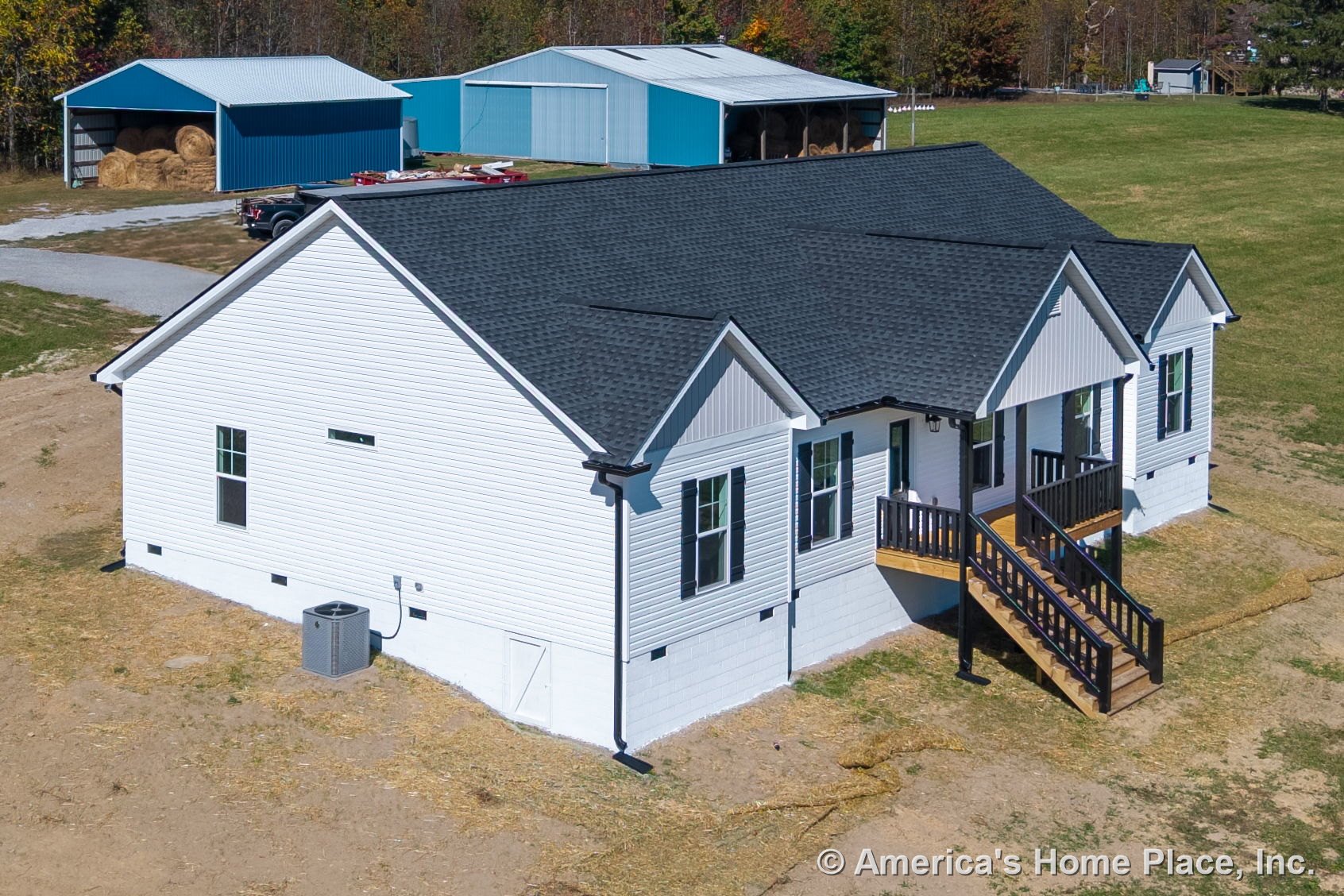 White vinyl siding exterior with black shingle roof, covered front porch featuring wooden steps, double-hung windows, exterior HVAC unit, white trim, entry door, foundation, and