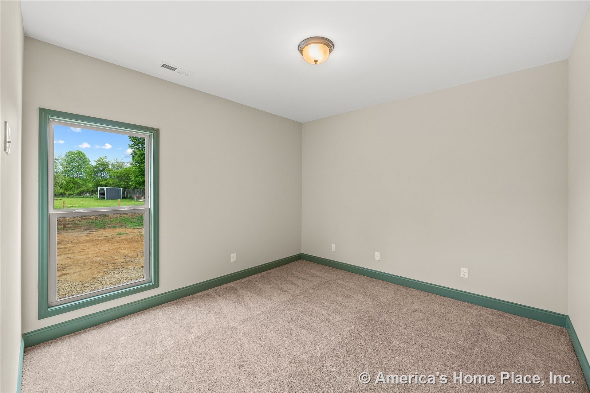 Bedroom with beige carpet flooring, neutral walls, single large window framed by green trim, matching green baseboards, flush mount ceiling light, and multiple electrical outlets.
