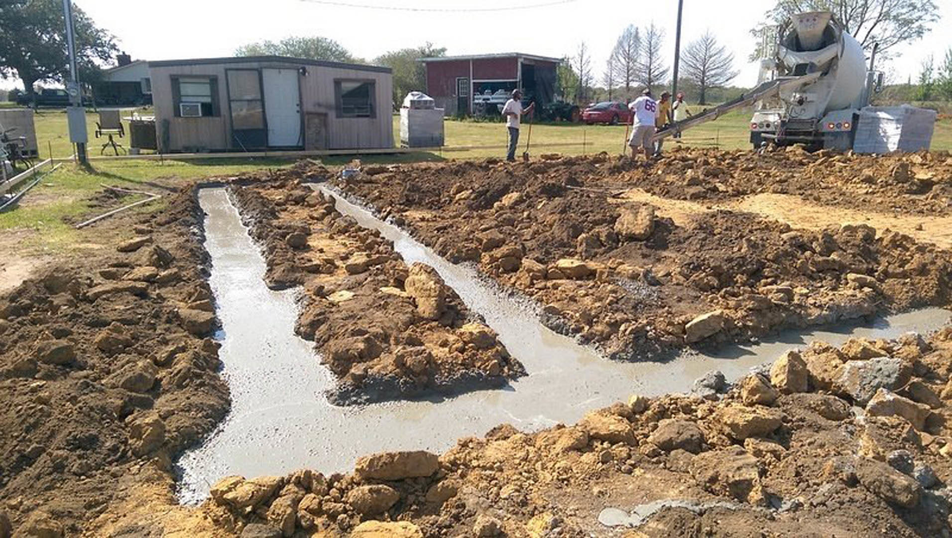 A group of people working in a dirt area.