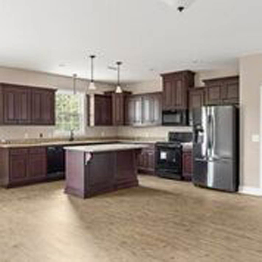 Dark wood kitchen cabinets, granite countertops, stainless steel refrigerator, light tile flooring, neutral painted walls