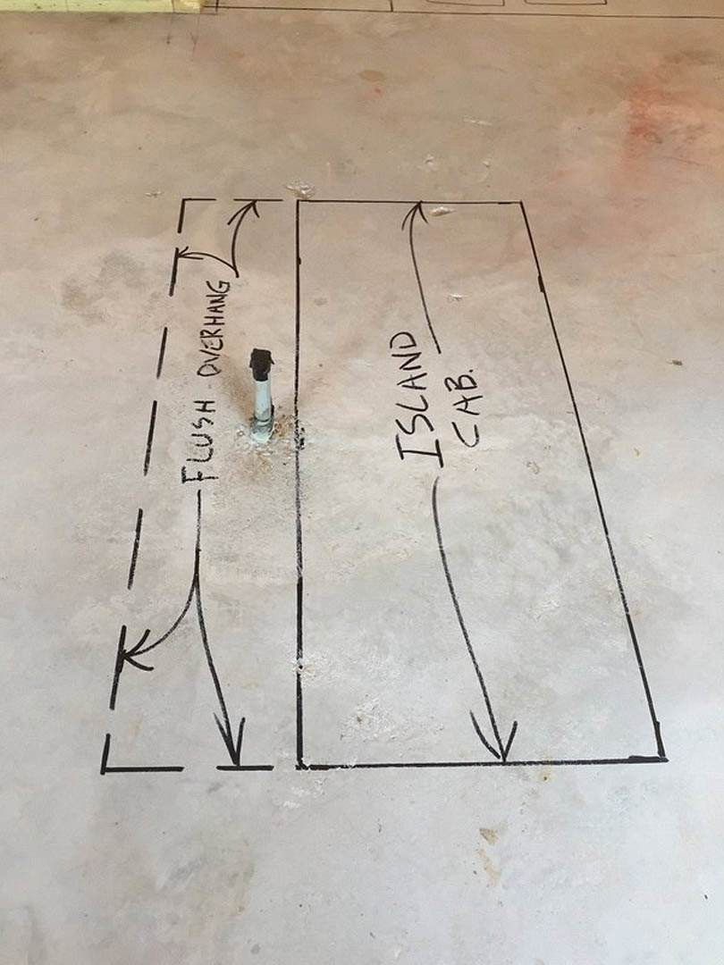 Hand-drawn sketch showing a hole in a concrete floor with a tube and pole, outlined in marker on a whiteboard.