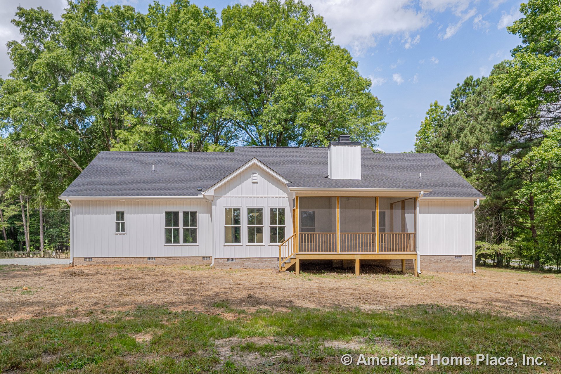Screened porch with wood railings, white vertical siding exterior, multiple windows, brick foundation, and dark shingle roof on a single-story home.