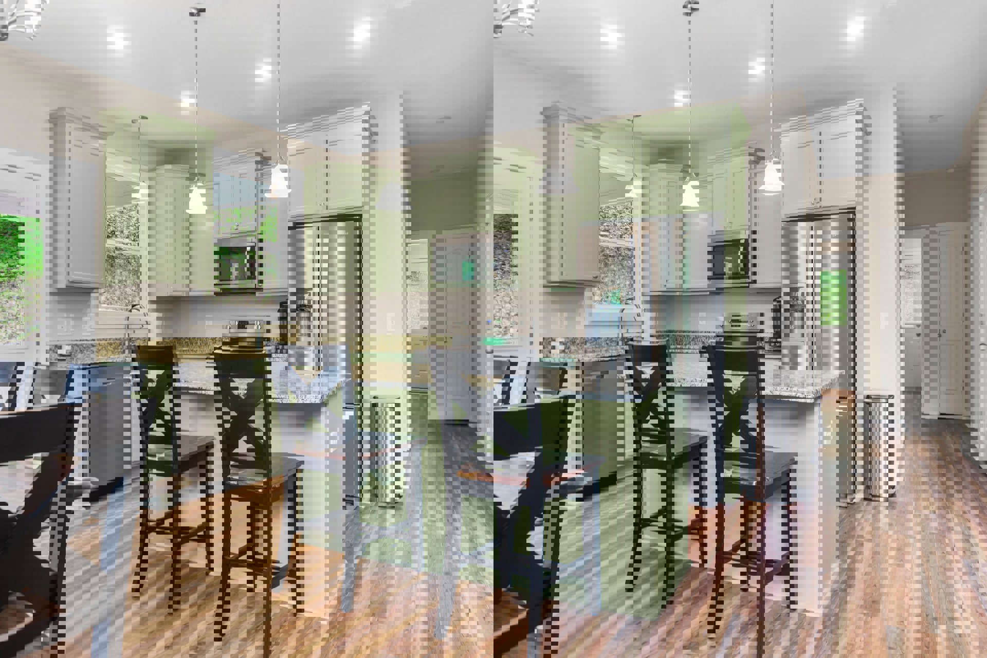 Green shaker cabinets, white quartz countertops, built-in microwave with glass door, wood barstool at peninsula, light wood flooring, white tile backsplash