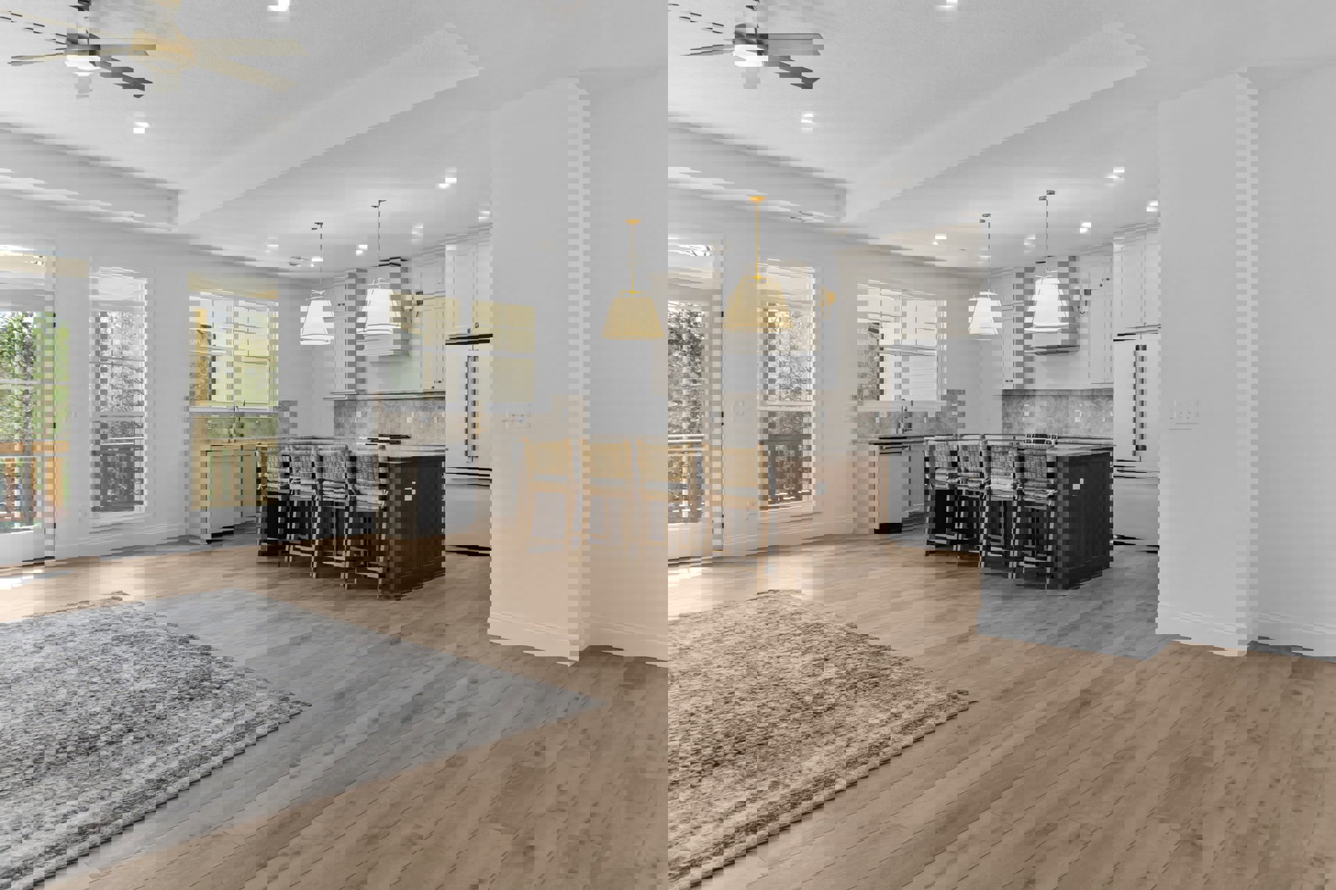 Open kitchen and dining area featuring wood flooring, a patterned rug beneath a large dining table, white cabinetry, a double-handle refrigerator, bar seating with chairs, and a