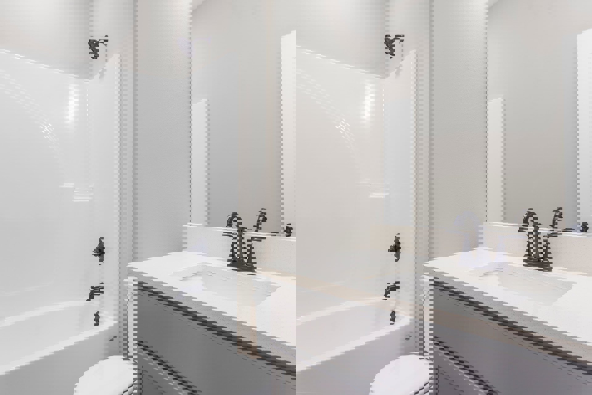 Modern bathroom featuring a white freestanding bathtub with matte black faucet, glass-enclosed shower with black showerhead, white rectangular sink with black tap, and light gray