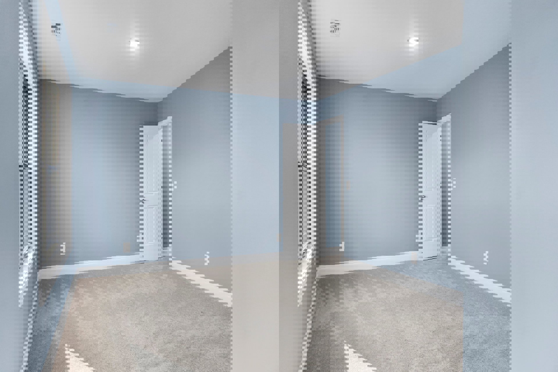 White paneled door with silver knob opens into carpeted room featuring white walls, ceiling light fixture, corner window, and tile flooring near entry.