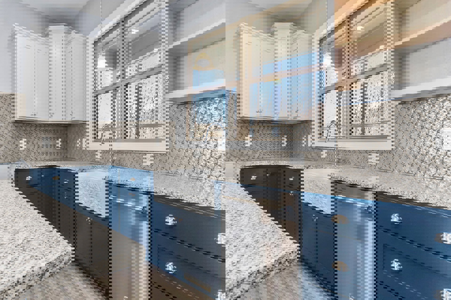 Kitchen with blue drawers, white cabinets, granite countertops, stainless steel dishwasher, undermount sink, and white ceiling