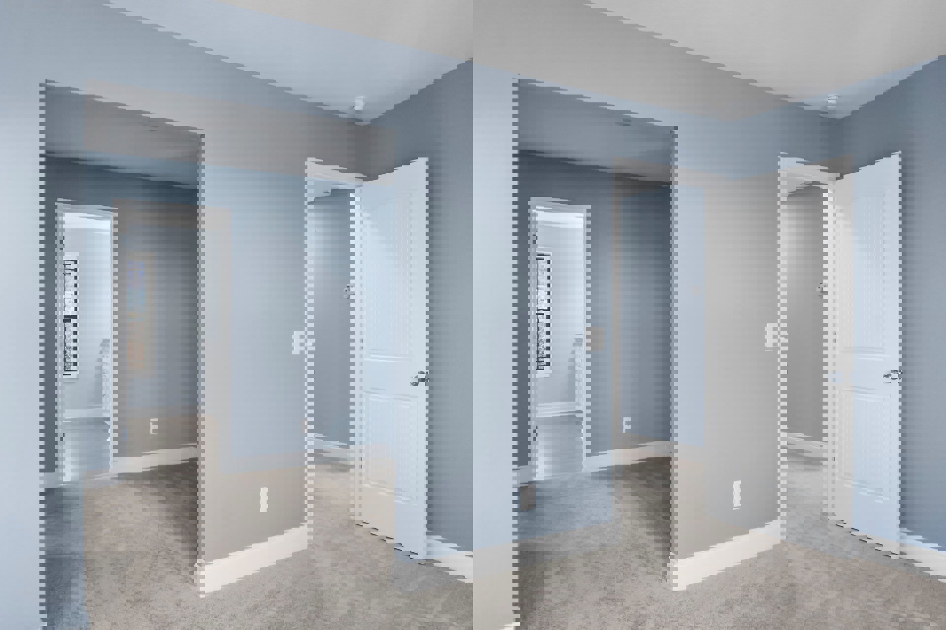 White paneled door with silver knob set in blue and white walls, hallway visible beyond, window shows clear sky, light wood flooring and smooth plaster ceiling.