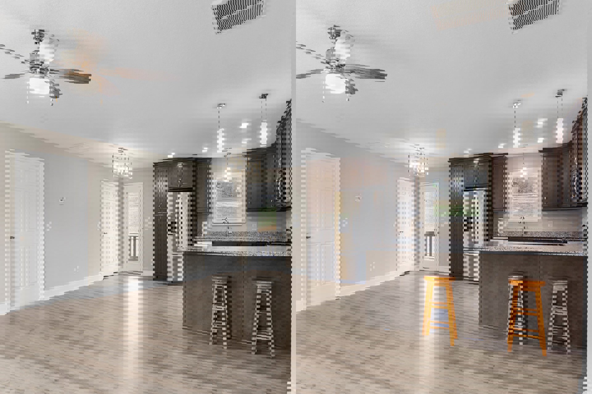 Open kitchen and living room with laminate flooring, white cabinetry, stainless steel refrigerator, ceiling fan, and wooden ladder leaning against a wall near a white door with