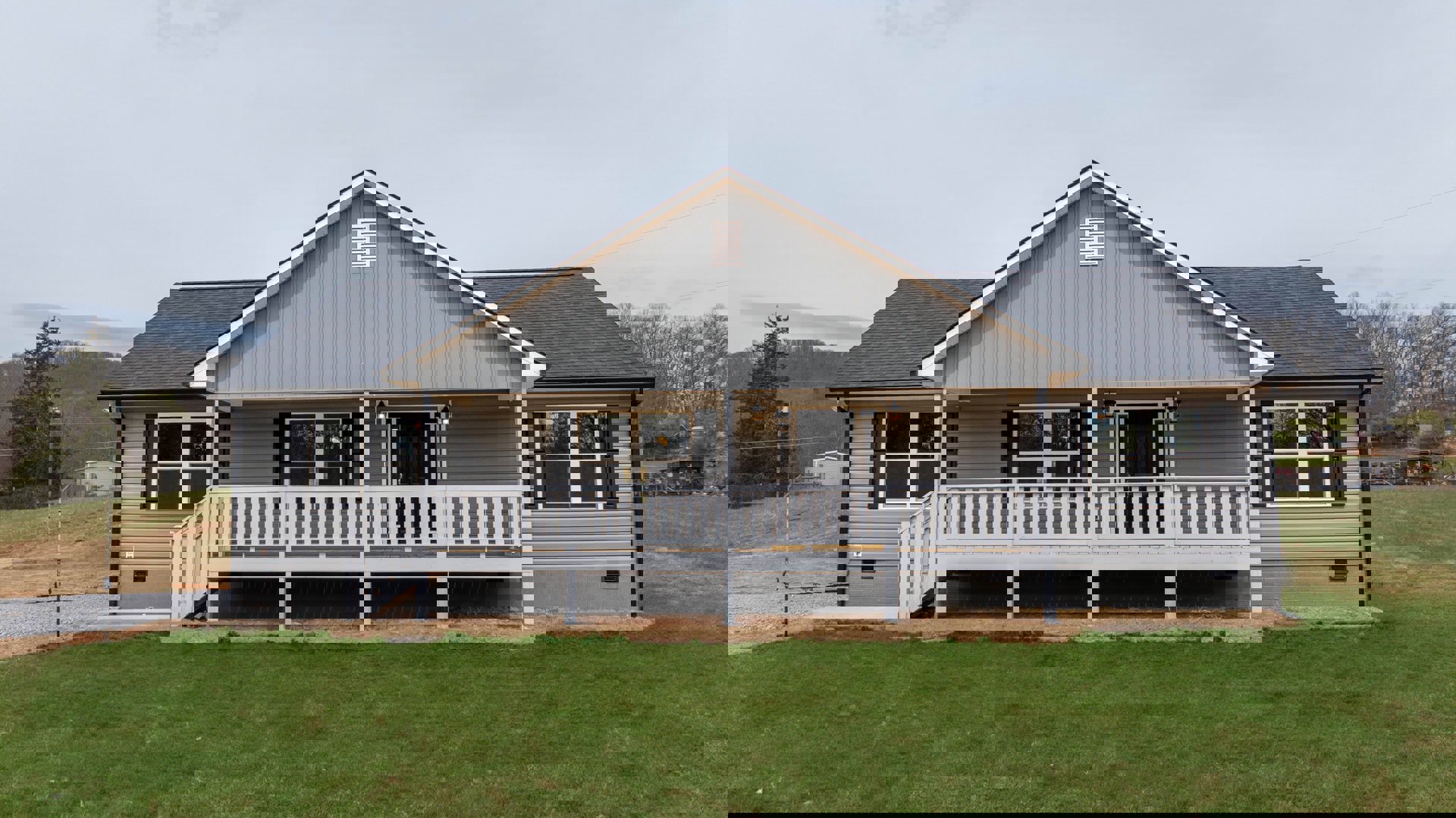 Two-story home with white porch railing, manicured lawn, white-framed windows, and Southfork Ranch visible in the background