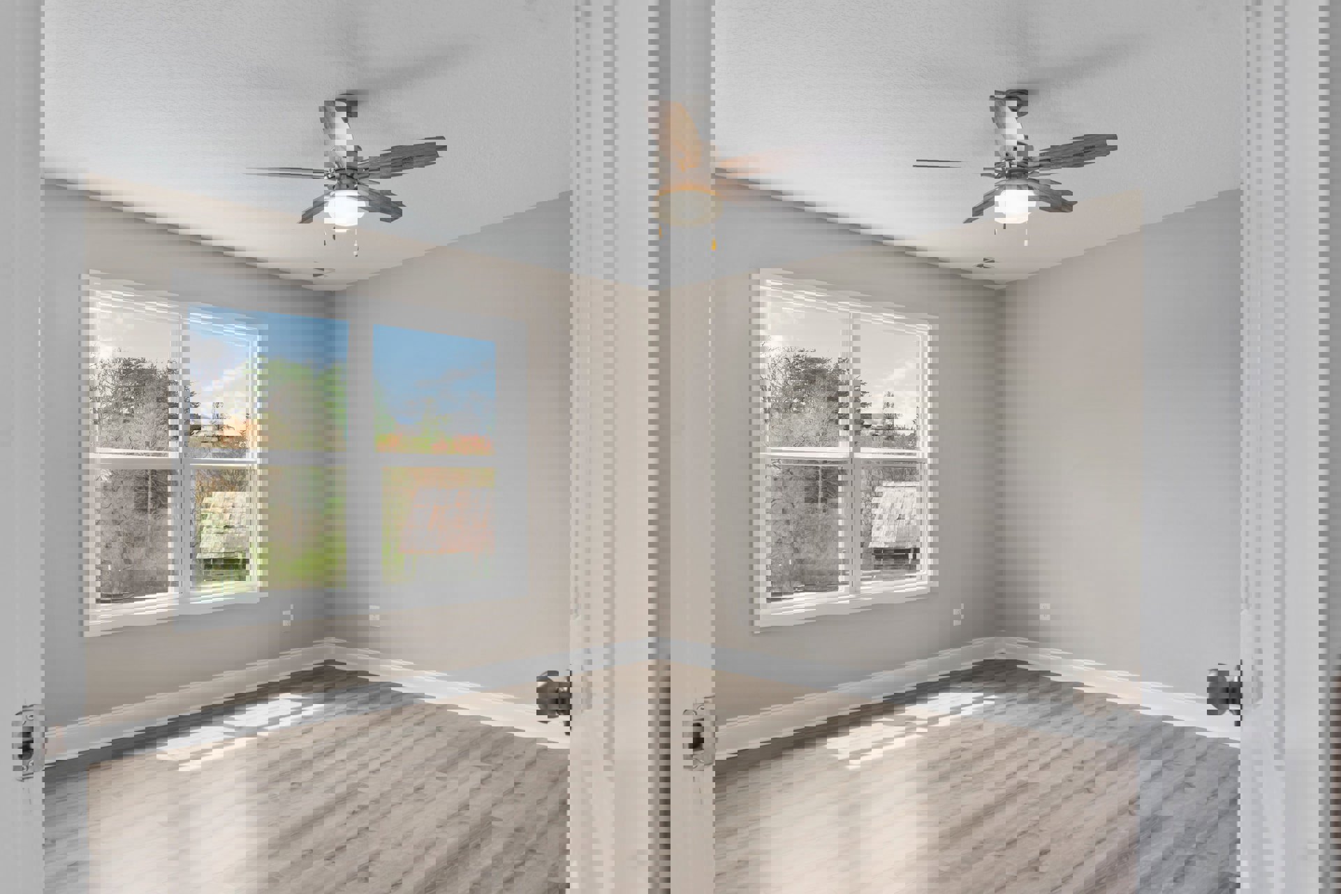 Ceiling fan with light fixture mounted on white plaster ceiling, large window overlooking house and trees, sunlight streaming onto wood floor, close-up of brass door knob, shed