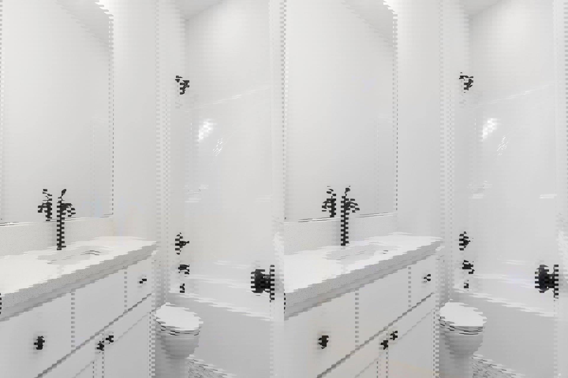 Modern bathroom featuring a white toilet, white bathtub with black knobs, black shower head and arm, close-up of chrome faucet, and white tile finishes