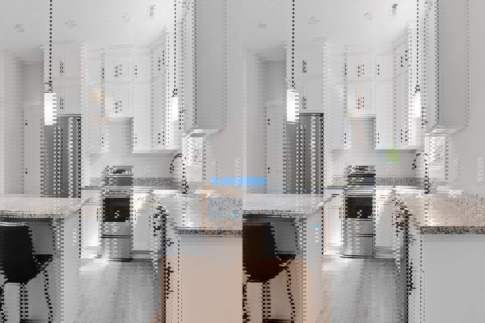 White kitchen cabinets with granite countertops, stainless steel oven with blue lid, white light fixture with black top, close-up of refrigerator, chair near counter, neutral walls