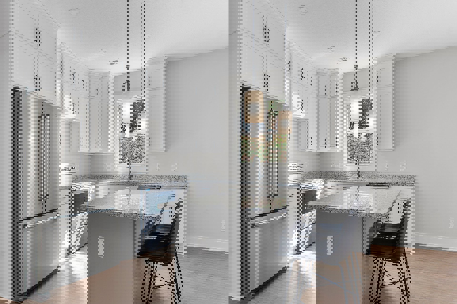 Marble kitchen island with built-in sink and curved faucet, stainless steel refrigerator, black chair, bar stools at counter, white cabinetry, light wood flooring