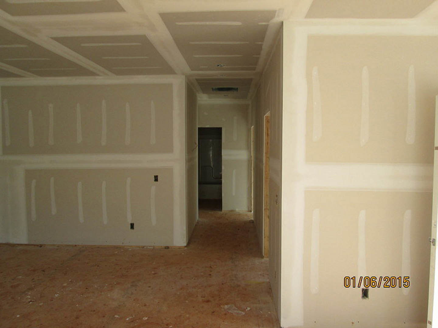 White-painted walls, paneled door with silver handle, light wood flooring, smooth plaster ceiling