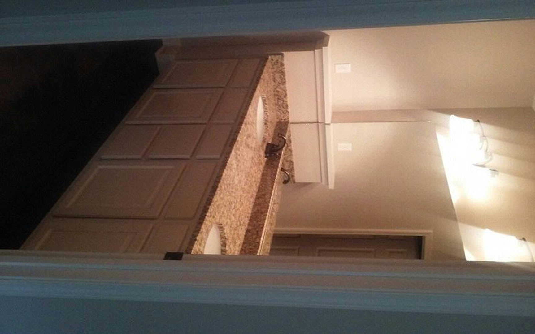 White quartz countertop with undermount stainless steel sink, subway tile backsplash, shaker cabinets, and pendant lighting in modern kitchen