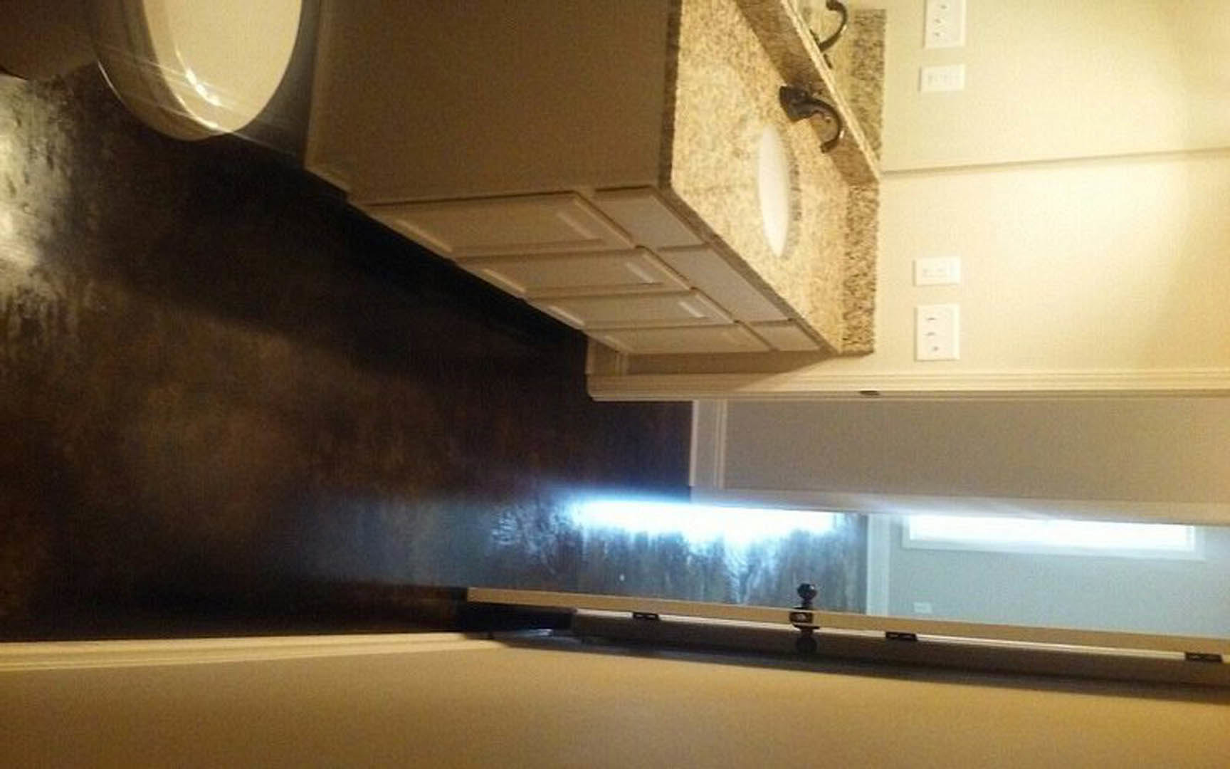 White porcelain sink and toilet set against light-colored walls, chrome faucet, recessed lighting, and tile flooring in a modern bathroom.