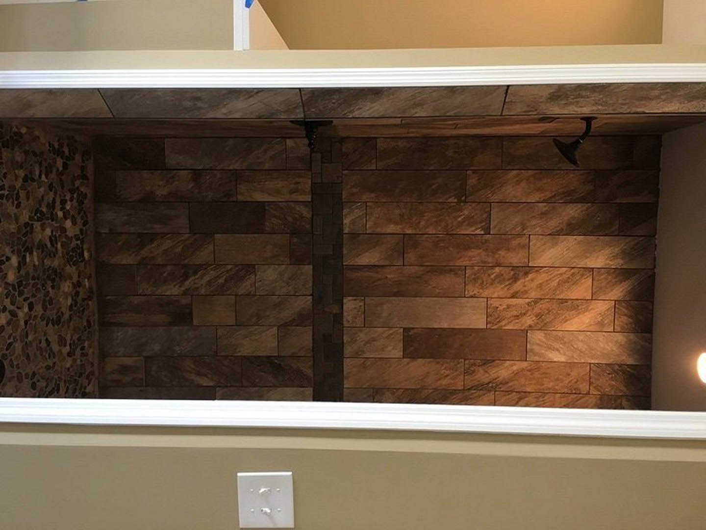 Small room featuring a wood accent wall, white plaster walls, ceiling light fixture, and visible light switch.